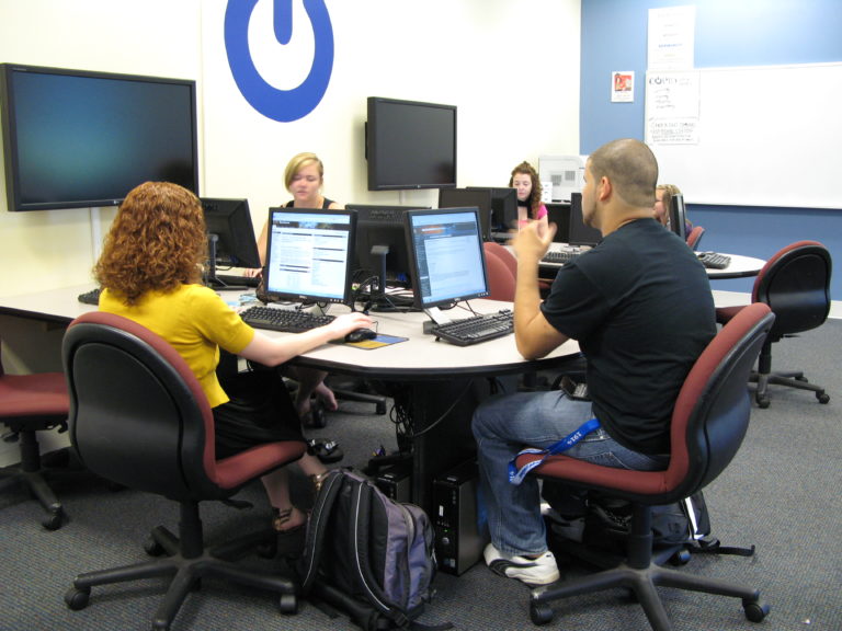 Students writing collaboratively in a computer classroom