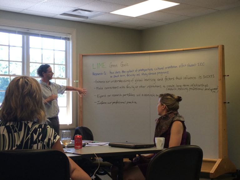 Research team working at whiteboard