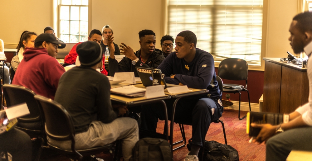 Freshman Mory Diakite engages in a thoughtful conversation with Damion Blake, assistant professor of political science and policy studies, during "The Black Man in America" class.