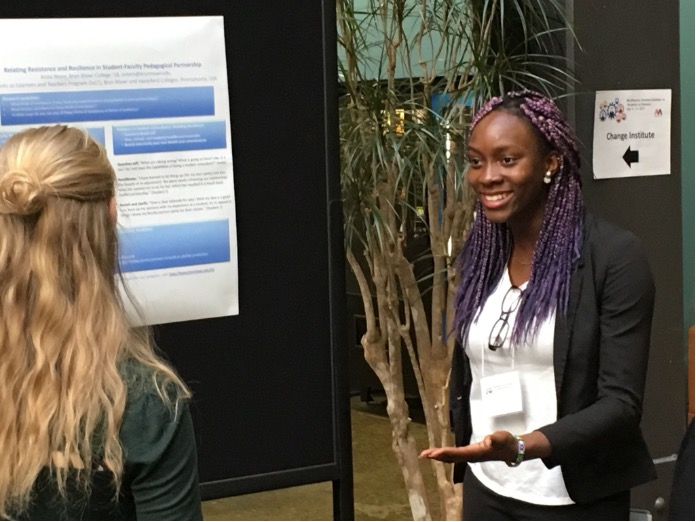 A black student presenting a research poster