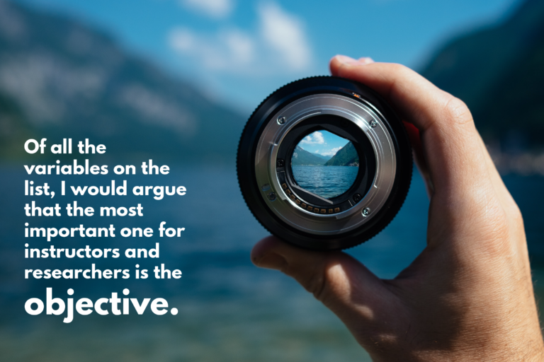 Photo of hand holding a camera lens in front of a view of mountains and lake. With text overlaid: "Of all the variables on the list, I would argue that the most important one for instructors and researchers is the objective."