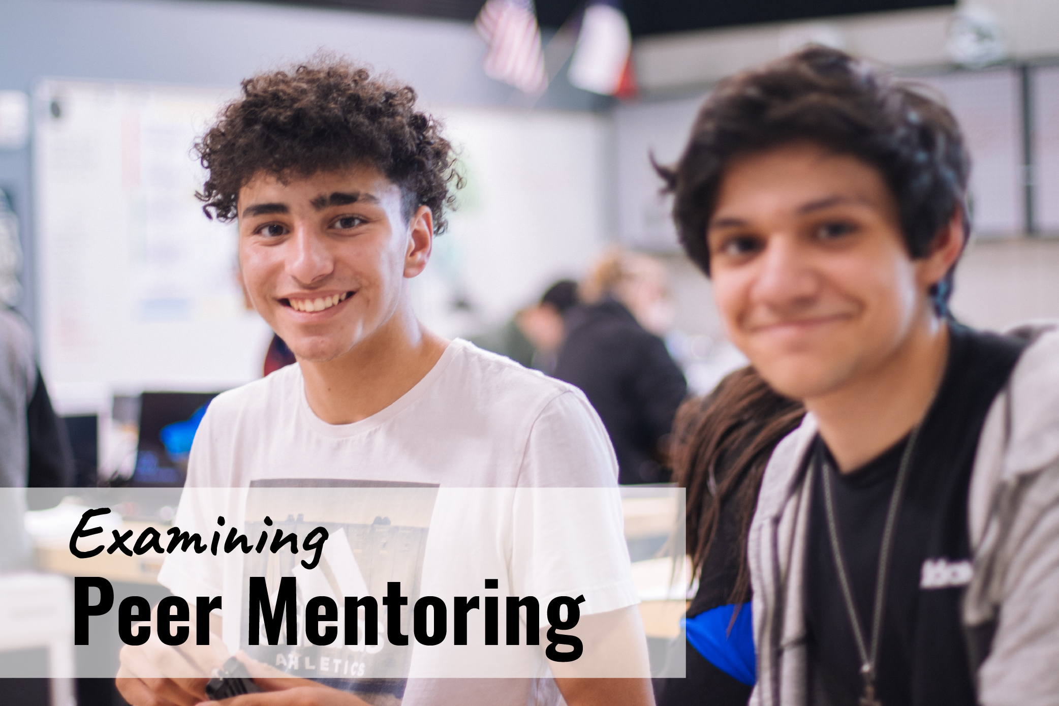 Two male students smile at the camera, with headline "Examining peer mentoring"