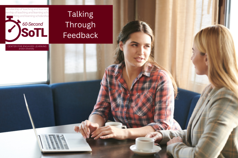 Two women sit at a desk. One has a laptop open with her hand hovering over the trackpad. Both have cups and saucers in front of them. An overlay reads, "Talking Through Feedback."