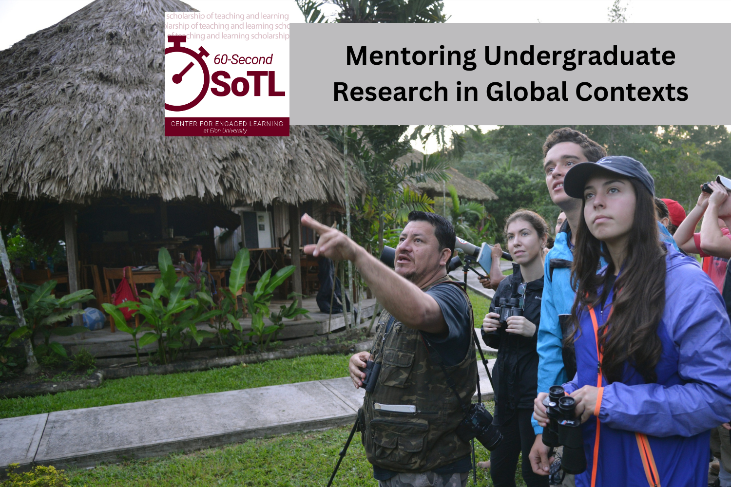 A group of people stand in front of a house with a grass roof. One person is pointing to something ahead of the group but out of frame. An overlay reads, "Mentoring Undergraduate Research in Global Contexts."