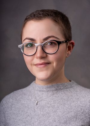 head shot of a woman with glasses and shortly trimmed hair