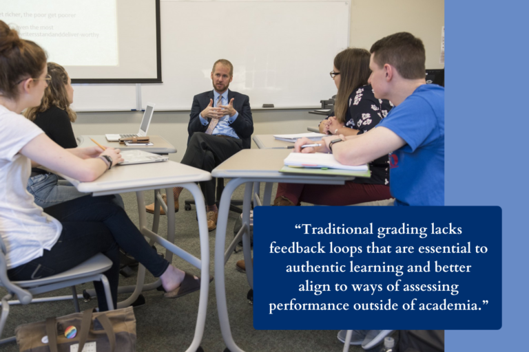 A group of students sit at desks around a seated man wearing a suit. Text overlay reads, "Traditional grading lacks feedback loops that are essential to authentic learning and better align to ways of assessing performance outside of academia."
