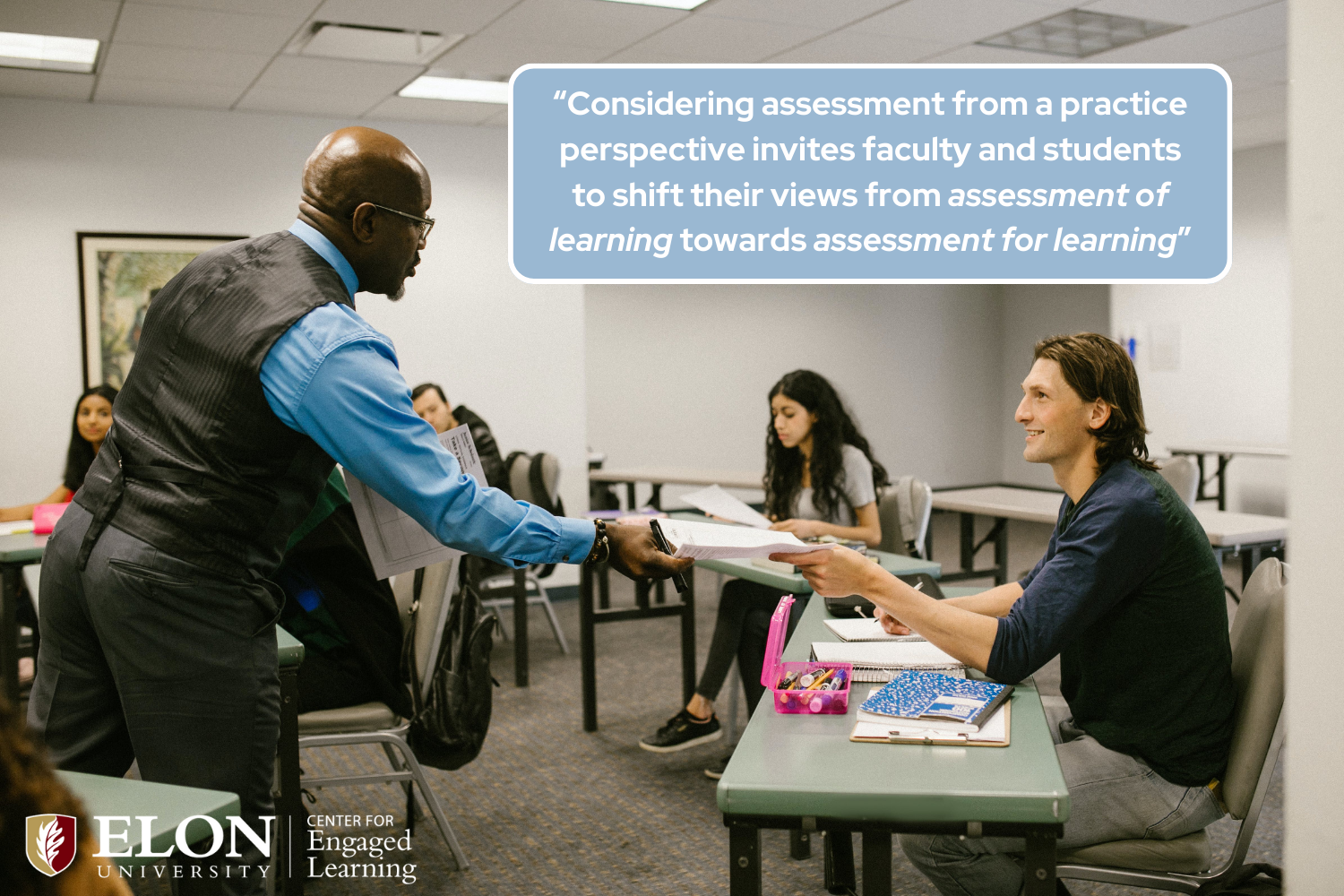 a professor passing a student a paper. "Considering assessment from a practice perspective invites faculty and students to shift their views from assessment of learning towards assessment for learning”