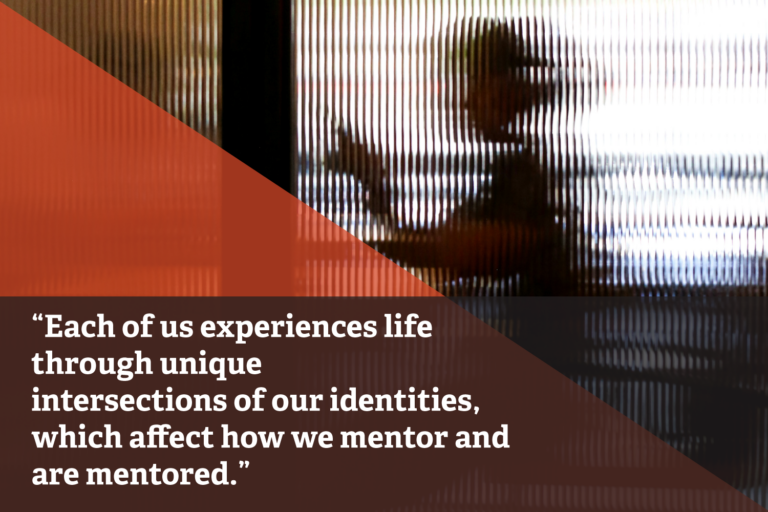 Woman sitting in an office behind translucent textured glass wall. Overlayed orange and dark brown diagonal shapes frame text that reads: "Each of us experiences life through unique intersections of our identities, which affect how we mentor and are mentored."