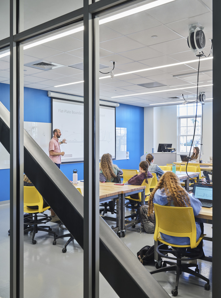 Students learn in a glass-walled classroom in Elon University's Founders Hall.